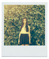 Bush, leaves and portrait of girl in nature for peace, zen and relax outdoors on polaroid. Female person, teenager and fashion in garden for trendy, style and summer vacation with serious face