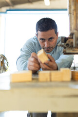 man working in a carpentry shop. Photographs of the work and backgrounds for publications with copy space.