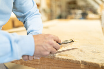 man working in a carpentry shop. Photographs of the work and backgrounds for publications with copy space.