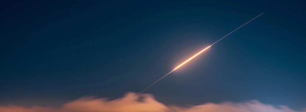 In the night sky, a missile interceptor zooms. It glows from the city lights. It defends the city against missiles.