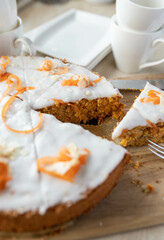 Carrots cake with almonds and powdered sugar icing