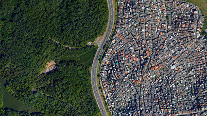 Forest and city border and road, forest and city separated by an s-shaped line, looking down aerial view from above – Bird’s eye view forest and city border Salvador, Bahia, Brazil