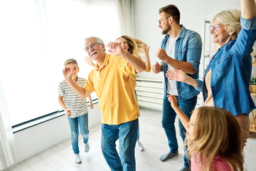 child family woman mother man father grandmother dancing music daughter group happy girl grandparent generation  grandchild together senior grandfather