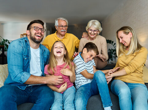 child family portrait woman mother man father grandmother daughter group smiling happy adult girl grandparent generation female grandchild together senior grandfather son boy three