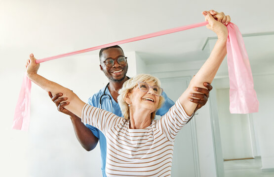 therapist senior woman exercise exercising patient physical therapy care nurse recovery physiotherapy fitness stretching stretch band elderly support training