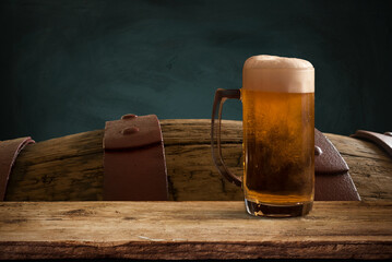 Oktoberfest beer barrel and beer glasses with wheat and hops on wooden table. High quality photo