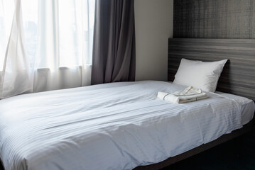 White pillow and bed sheet at hotel bedroom in Japan.