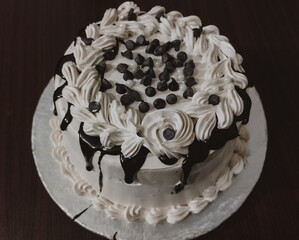 Delicious Birthday Cake with White Cream and Chocolate on wooden table top View - Sweet Dessert