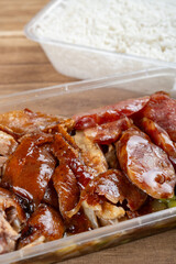 angle view fast food with roasted ducks and chinese style sausages and rice at vertical composition