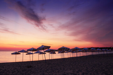 beach on the black sea at dawn. leisure and travel background in summer. velvet season. red clouds on the sky