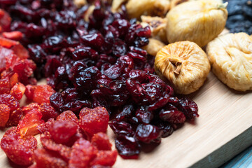 Dried fruits arrangement includes raisins, goldenberries, figs, and apricots, presenting a vibrant...