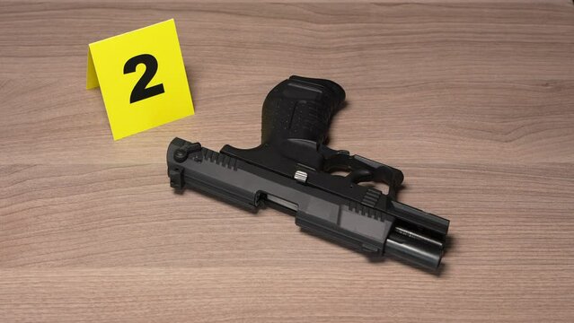 Crime Scene Investigation - handgun as a piece of evidence tagged by yellow marker