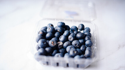 Box with fresh blueberries on white background.