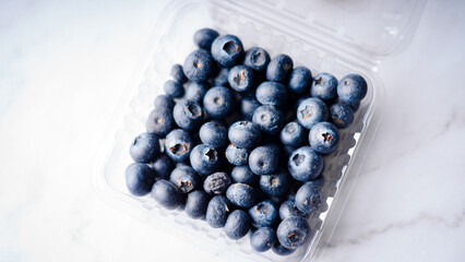 Box with fresh blueberries on white background.