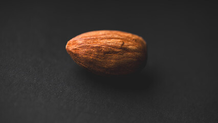 Close-up macro shot of an Almond on a black background.