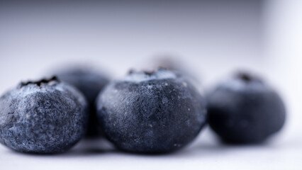 Close up macro shot of fresh blueberries on a white background.
