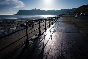 Scarborough Castle silhouetted with beach and ocean