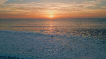 Bright sunset shining sea surface drone view. Stunning summer sun setting down