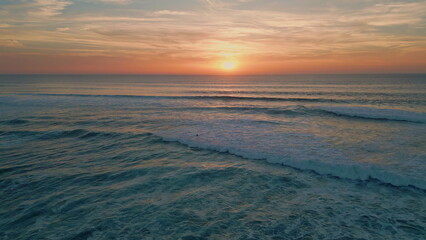 Fototapeta na wymiar Golden sunset sky ocean horizon aerial view. Summer sundown reflecting in sea