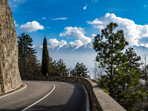 Road between the villages of Vesio and Voltino in Tremosine on Lake Garda. The Monte Baldo mountain range in the background.