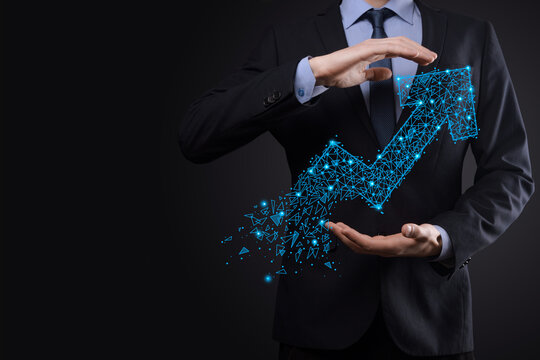 Businessman hold graph, arrow of positive growth icon.pointing at creative business chart with upward arrows.Financial, business growth concept.Low polygonal.increased sales, or increased value