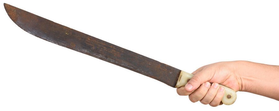 Hand holding an old, rusty machete, a tool used to cut bushes