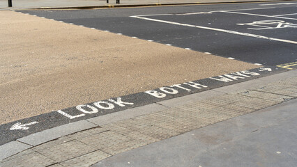 Look both ways written on a pedestrian crossing