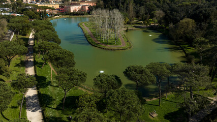 Aerial view of the small lake of Villa Ada, a public park in Rome, Italy. In the center of the lake...