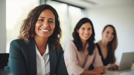 A group of diverse, confident, women working together, smiling, in an office, business environment