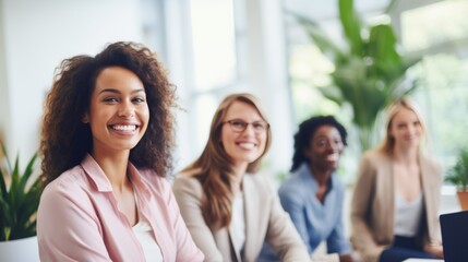 A group of diverse, confident, women working together, smiling, in an office, business environment