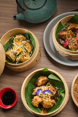 Group of delicious Japanese vegetable gyosas on a traditional bamboo pot, vietnamese food. Pho ga,...