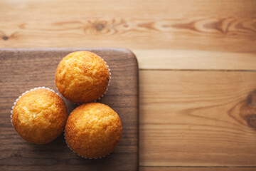 Top view of cupcakes on top of a walnut wood. Pastry. Copy space.