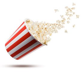 Popcorn flying from red and white striped container, isolated on white background. - 753732242