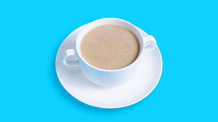 Mushrooms soup bowl isolated on blue