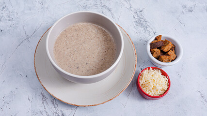 Mushrooms soup bowl, crackers and cheese