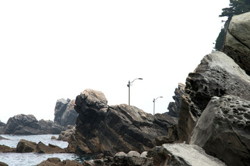 View of the seaside rocks against the street lamps