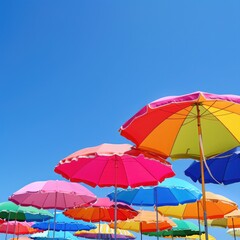 Colorful Beach Umbrellas Under a Clear Blue Sky on a Sunny Day