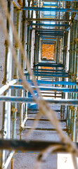 A long row of scaffolding with a rope hanging down