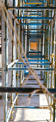 A long row of scaffolding with a rope hanging down