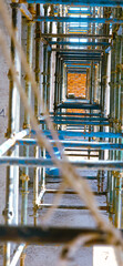 A long row of scaffolding with a rope hanging down
