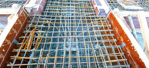 A construction site with a metal grid on the floor. The grid is made of metal and is in the shape of a diamond