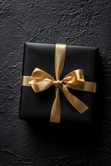 Close up black gift on black background with copyspace. Valentine's day, black friday, romance, love, wedding anniversary concept