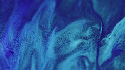 Glitter paint spill. Ink mix. Defocused blue color shimmering texture fluid emulsion wave motion...