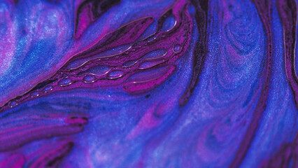 Glitter paint bubbles. Ink water mix. Defocused purple blue red color shiny oil liquid blend splash motion abstract art background.