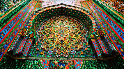 A stunning photograph of an intricately designed Islamic ornamental wall with vibrant mosaic details