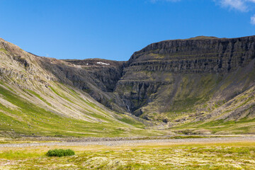 iconic panoramic Mountain View at Sauðlauksdalur next to the famous shipwreck in iceland. In front...