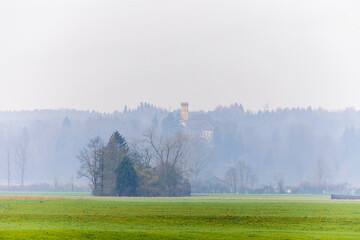 Wellenburg Castle in the mists above the western forests near Augsburg