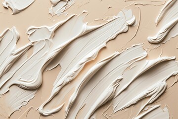 Close up acrylic paint or cosmetic brush strokes of creamy texture neatly smeared on a light background