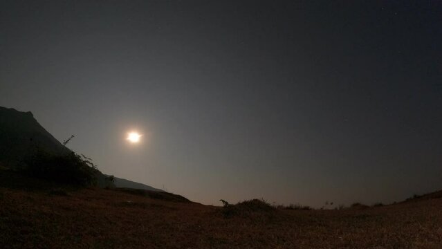 The moon rises from the sky on a full moon day. Location at national park in Vientiane, Laos.