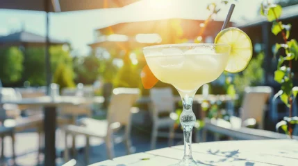 Fototapeten Citrus cocktail on restaurant patio table, warm summer sunlight © Kondor83